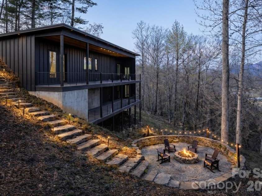 130 Midway Crossing Drive, Clyde, NC 28721.  MLS# CAR4321878, YatesRealty ID 12636. Concept rendering showing potential outdoor fire pit and seating area. Image is virtually enhanced for illustration purposes only.
