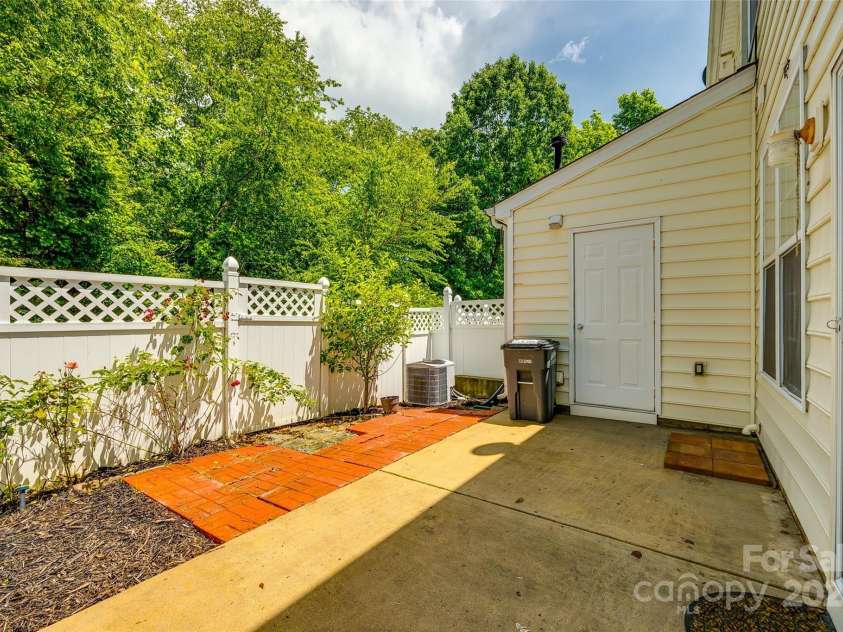 975 Copperstone Lane, Fort Mill, SC 29708.  MLS# CAR4253379, YatesRealty ID 12645. Fenced rear patio with woods behind for privacy and storage/utility room
