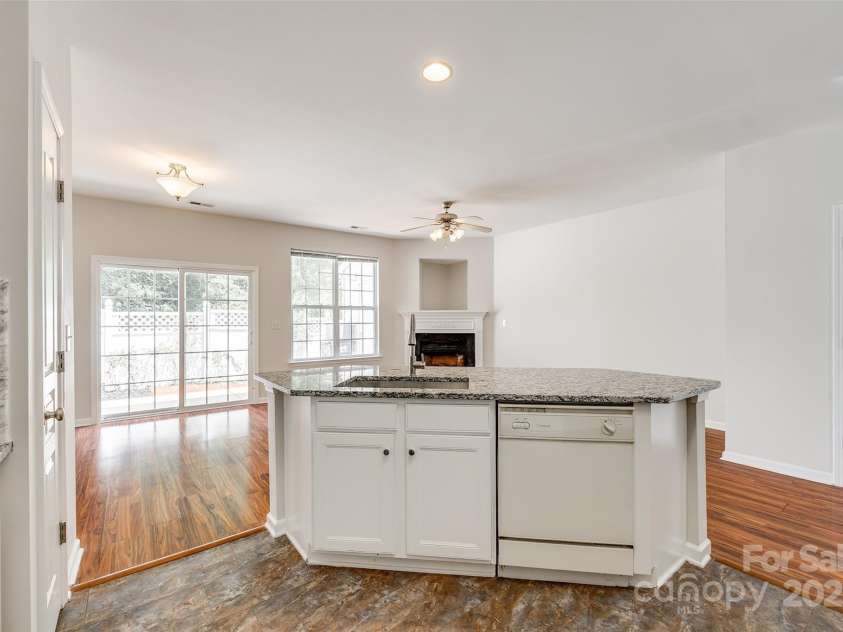 975 Copperstone Lane, Fort Mill, SC 29708.  MLS# CAR4253379, YatesRealty ID 12645. Kitchen open to living room with gas fireplace