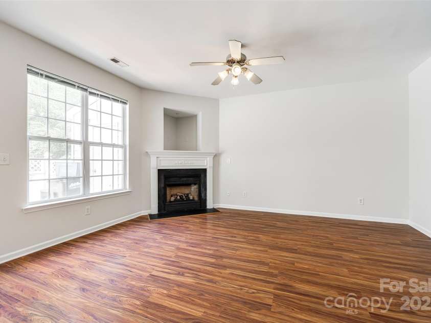 975 Copperstone Lane, Fort Mill, SC 29708.  MLS# CAR4253379, YatesRealty ID 12645. Living room with laminate flooring and gas fireplace