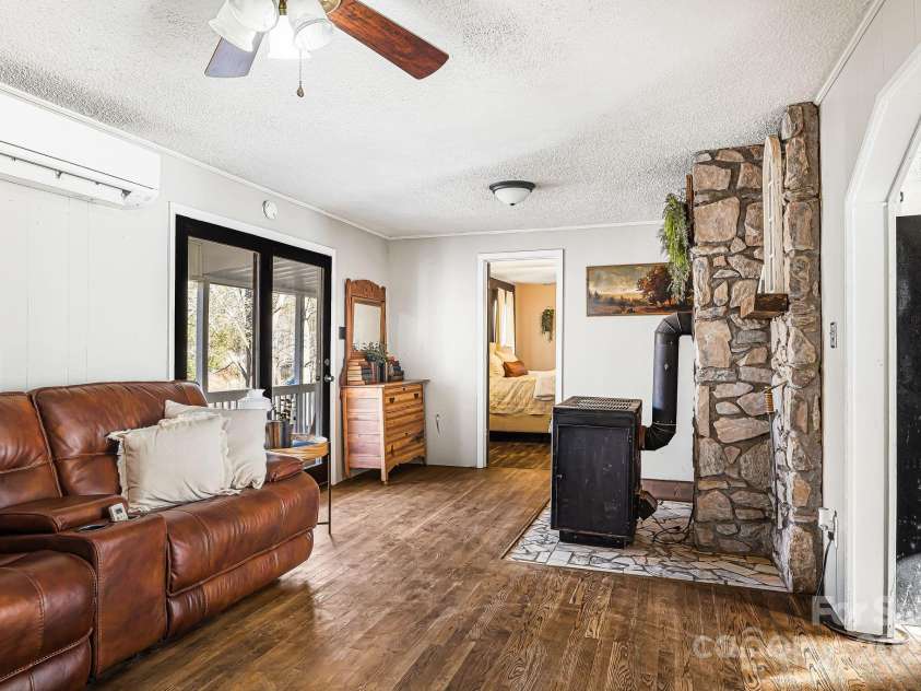 1178 Fork Road, Marshall, NC 28753.  MLS# CAR4219745, YatesRealty ID 12676. Living room, view of primary bedroom and front door