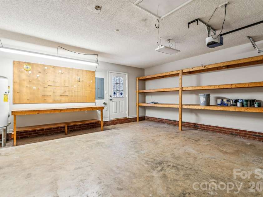 8307 Poplar Grove Circle, Waxhaw, NC 28173.  MLS# CAR4357386, YatesRealty ID 12689. Garage w Built-in Storage & Work Bench