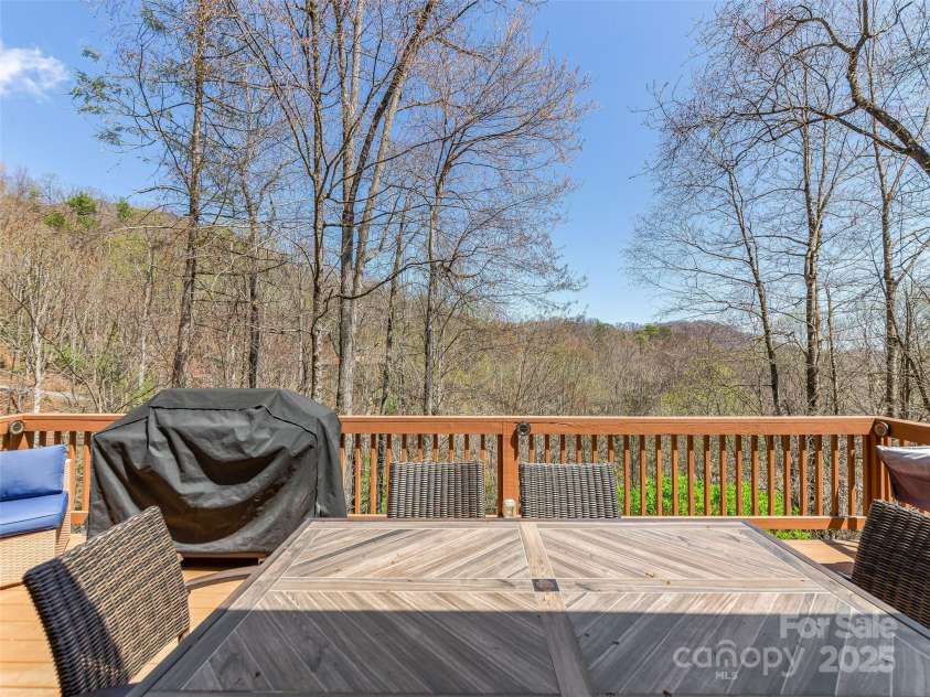 860 Creekside Drive, Maggie Valley, NC 28751.  MLS# CAR4245544, YatesRealty ID 12700. Dining area on the front deck, with mountain views.