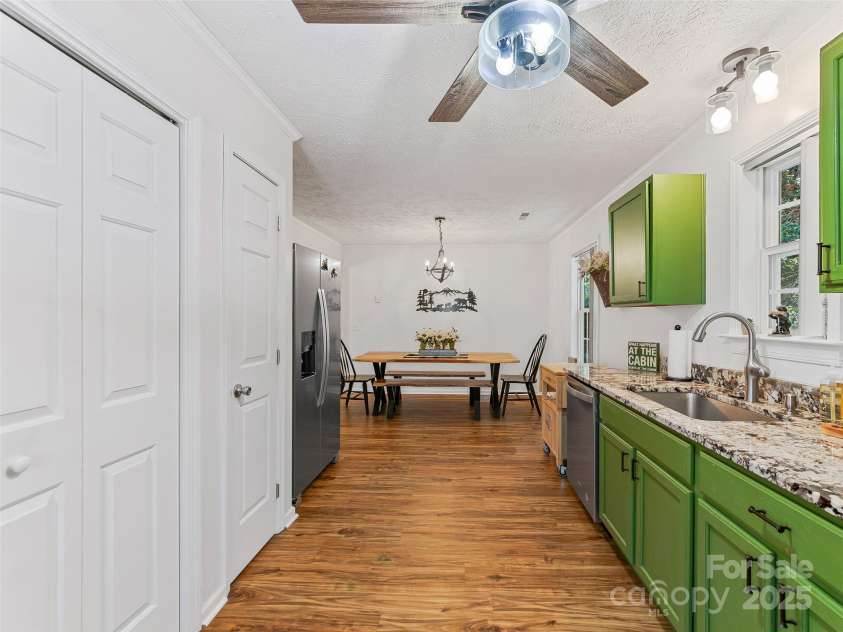 860 Creekside Drive, Maggie Valley, NC 28751.  MLS# CAR4245544, YatesRealty ID 12700. Galley style kitchen with laundry closet to the left.