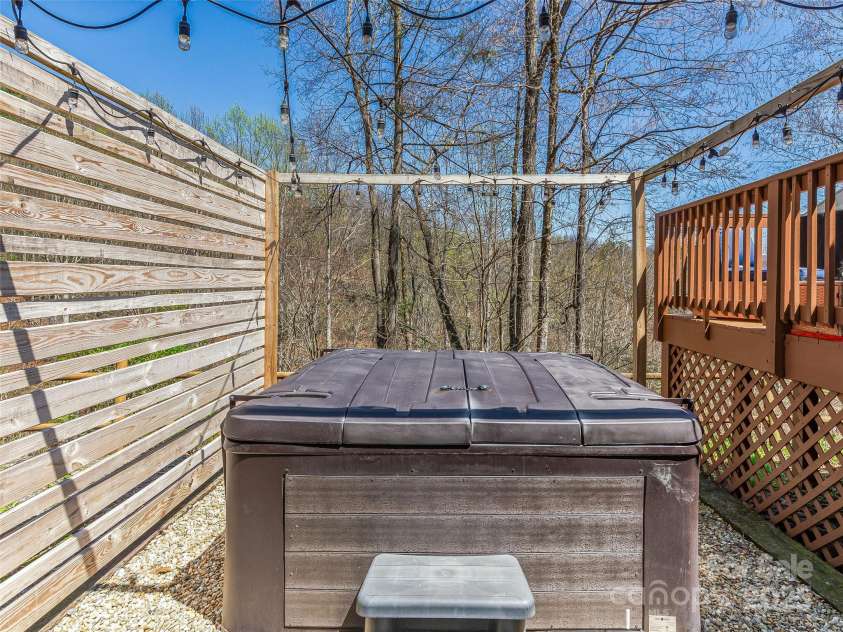 860 Creekside Drive, Maggie Valley, NC 28751.  MLS# CAR4245544, YatesRealty ID 12700. Hot tub area with privacy fence.