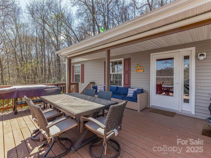 860 Creekside Drive, Maggie Valley, NC 28751.  MLS# CAR4245544, YatesRealty ID 12700. Porch features a roll out sun shade.