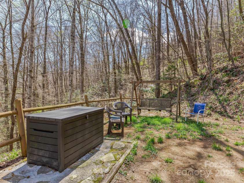 860 Creekside Drive, Maggie Valley, NC 28751.  MLS# CAR4245544, YatesRealty ID 12700. Side yard.