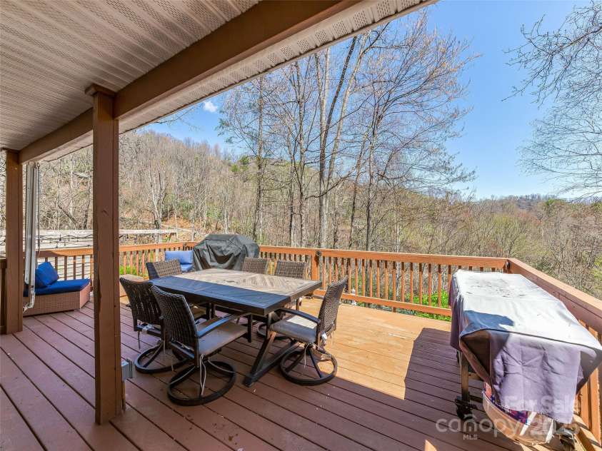 860 Creekside Drive, Maggie Valley, NC 28751.  MLS# CAR4245544, YatesRealty ID 12700. This impressive deck is an entertainer's dream, providing the perfect backdrop for outdoor meals and enjoying the natural beauty.