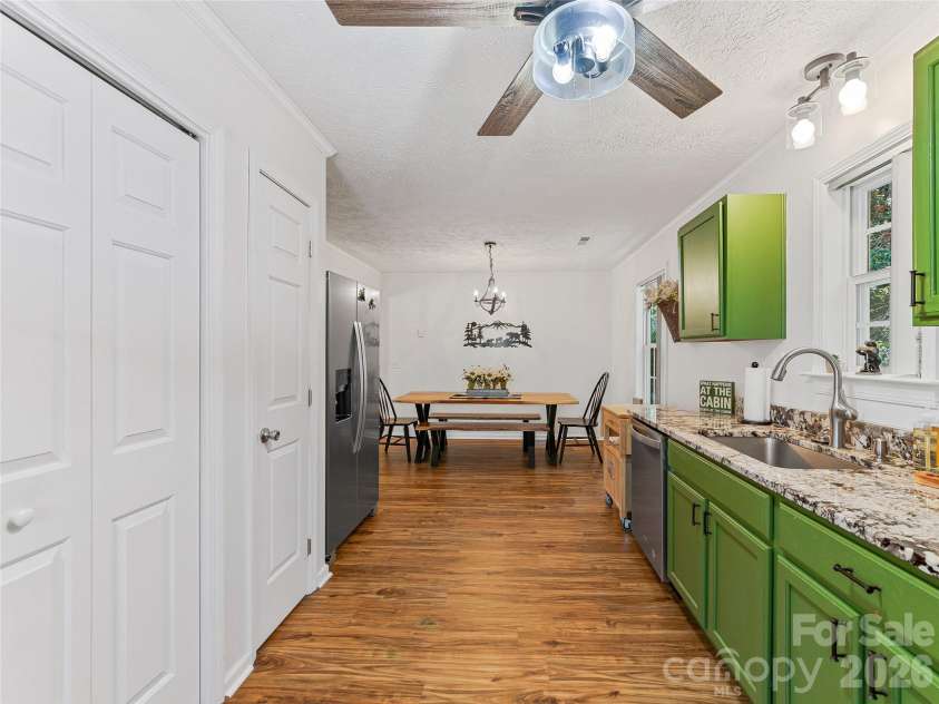 860 Creekside Drive, Maggie Valley, NC 28751.  MLS# CAR4329432, YatesRealty ID 12700. Entrance in to home with kitchen on the right and laundry closet on the left.