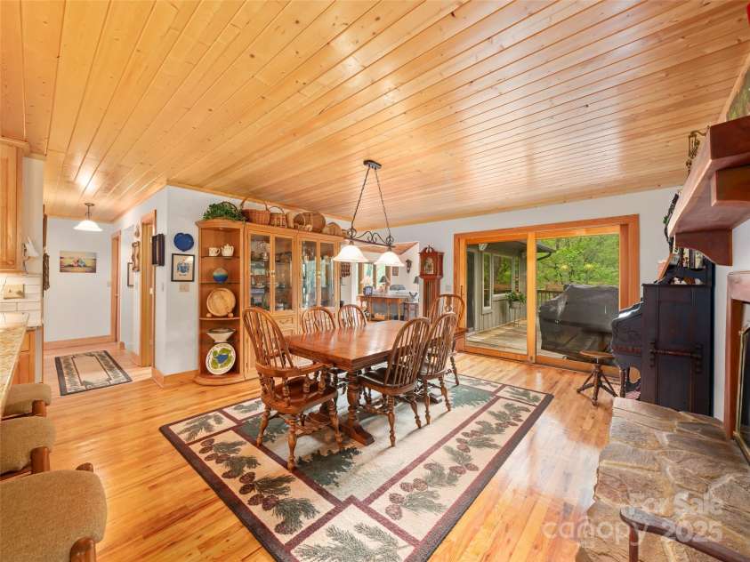 86 Laurel Drive, Burnsville, NC 28714.  MLS# CAR4253522, YatesRealty ID 12702. Dining area has sliding glass doors to open Grilling deck and screened in porch and a fireplace with mantle