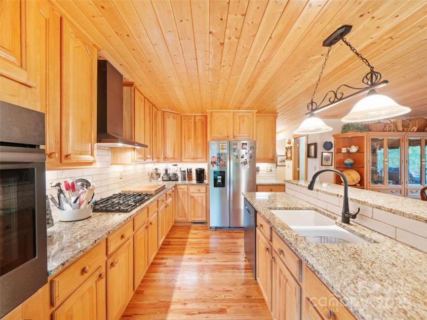 86 Laurel Drive, Burnsville, NC 28714.  MLS# CAR4253522, YatesRealty ID 12702. Kitchen has double wall ovens and kitchen Island with large sink and disposal 