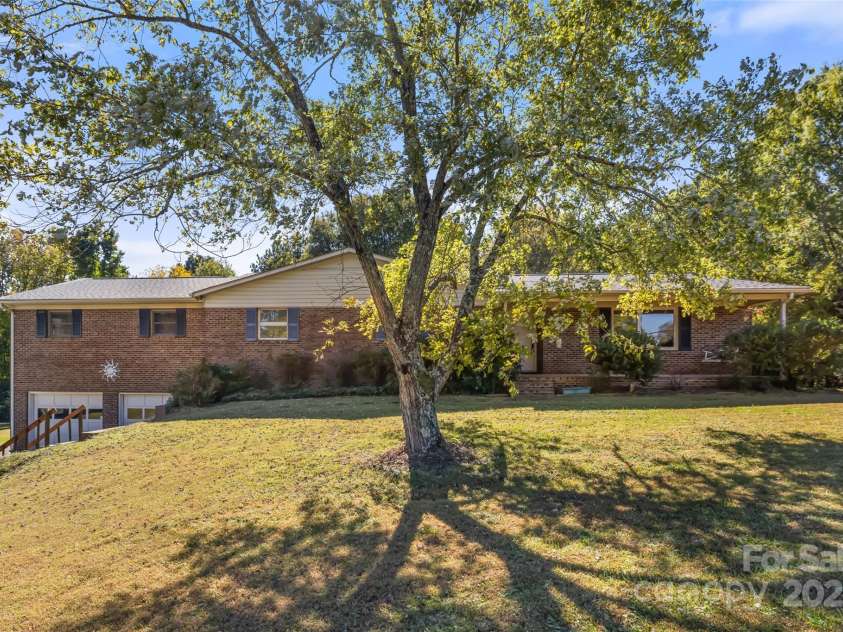 5303 Rogers Road, Monroe, NC 28110.  MLS# CAR4312504, YatesRealty ID 12706. Mature trees, vibrant azaleas, brick ranch with hardwood floors