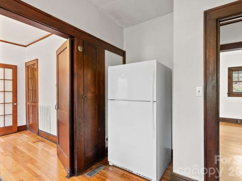 15 Conestee Place, Asheville, NC 28801.  MLS# CAR4358029, YatesRealty ID 12711. Refrigerator is positioned behind the small breakfast bar.