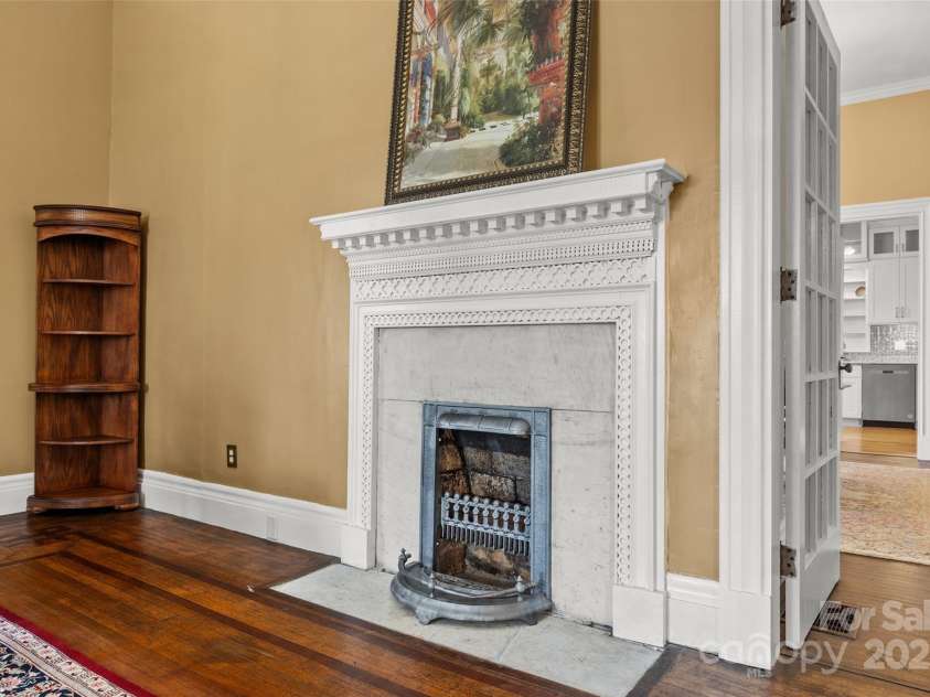121 Congress Street, York, SC 29745.  MLS# CAR4235428, YatesRealty ID 12723. Hand-carved mantel and vintage tilework—one of many original fireplaces showcasing the home's 19th-century craftsmanship and architectural significance.