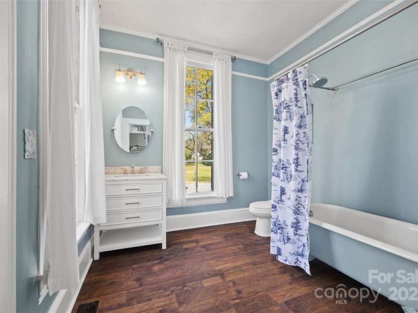 121 Congress Street, York, SC 29745.  MLS# CAR4235428, YatesRealty ID 12723. Primary Bedroom RetreatLight pours into this inviting space, showcasing tall ceilings, period details, and timeless style. Tb is over 100 yrs old