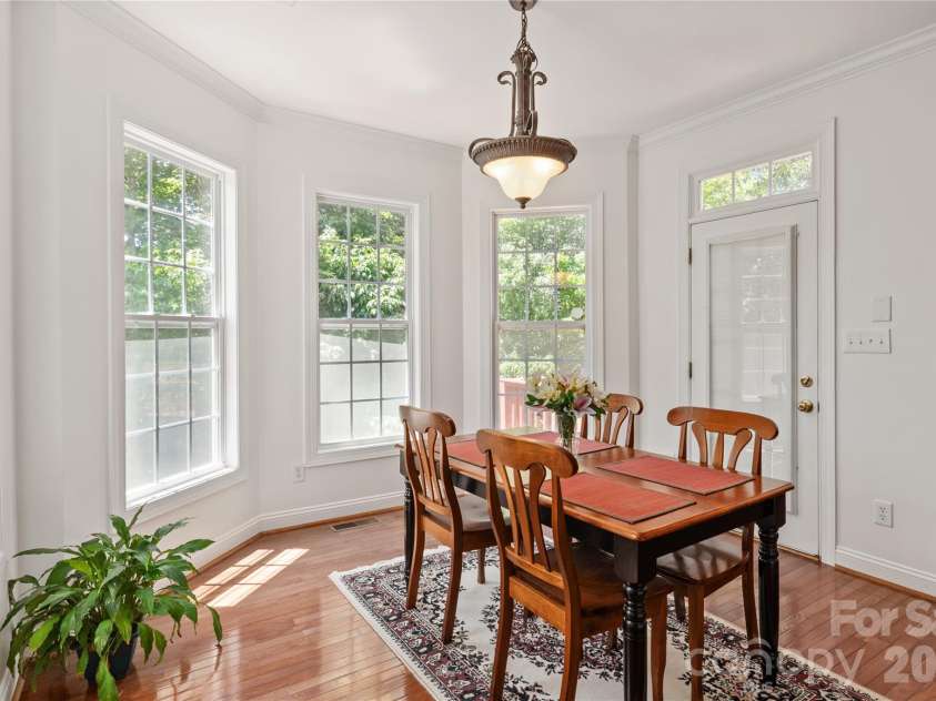 8914 Landsdowne Avenue, Harrisburg, NC 28075.  MLS# CAR4259422, YatesRealty ID 1276. Breakfast area overlooking the trees in the back yard and a side door to the deck.