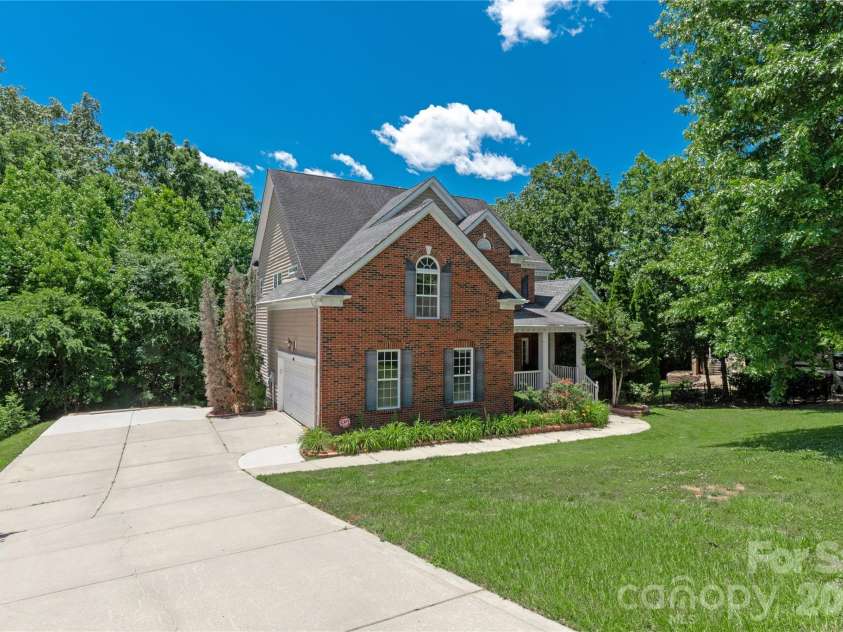 8914 Landsdowne Avenue, Harrisburg, NC 28075.  MLS# CAR4259422, YatesRealty ID 1276. Extended concrete driveway to garage and back yard.