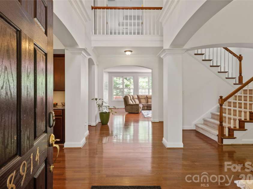 8914 Landsdowne Avenue, Harrisburg, NC 28075.  MLS# CAR4259422, YatesRealty ID 1276. Foyer to 8914 Landsdowne Avenue showing hardwood floors and beautiful architectural arches.