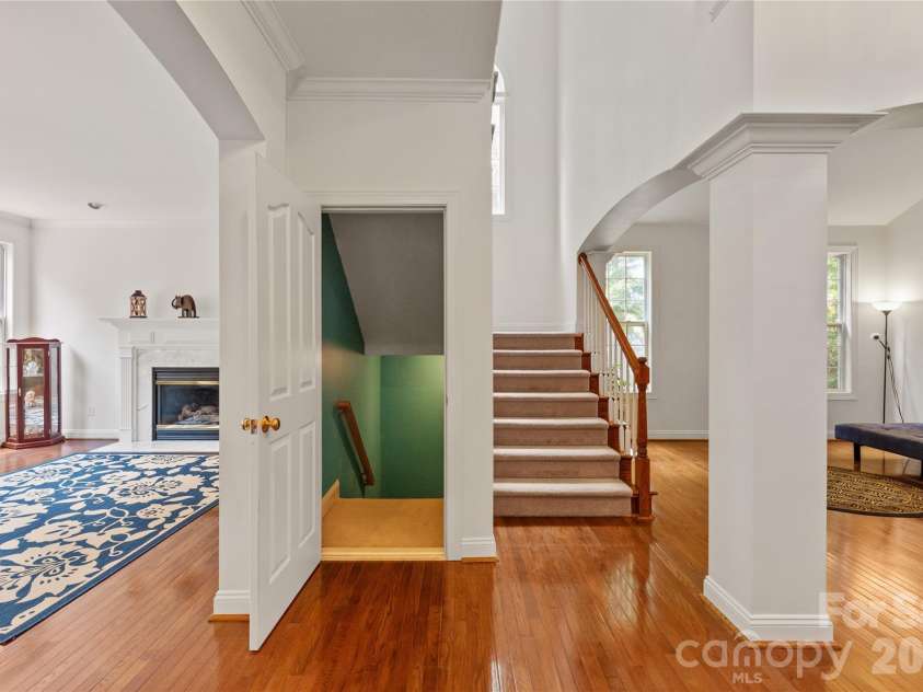 8914 Landsdowne Avenue, Harrisburg, NC 28075.  MLS# CAR4259422, YatesRealty ID 1276. Partial view of formal living room, family room, entry to the basement and stairs to 2nd floor.  Notice the height of the ceiling and the openness and spacious area.