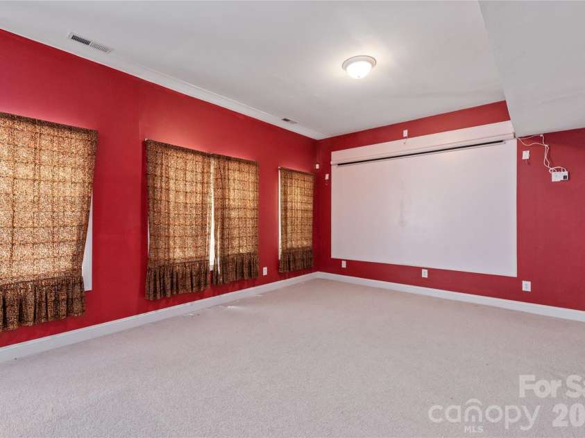 8914 Landsdowne Avenue, Harrisburg, NC 28075.  MLS# CAR4259422, YatesRealty ID 1276. Rec room with large TV screen.