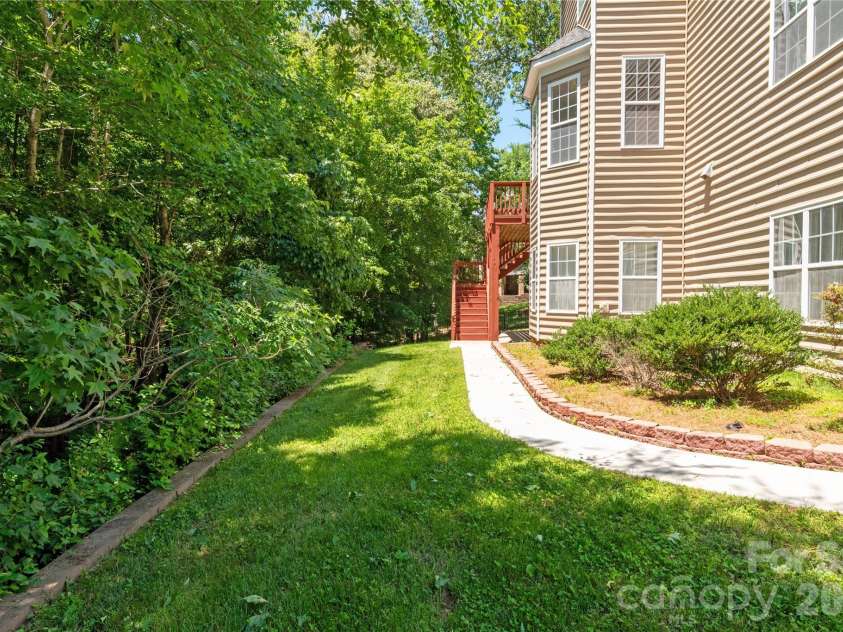 8914 Landsdowne Avenue, Harrisburg, NC 28075.  MLS# CAR4259422, YatesRealty ID 1276. View of walk way in the back yard.