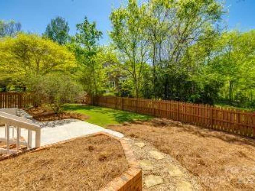 4340 Sequoia Red Lane, Charlotte, NC 28226.  MLS# CAR4233979, YatesRealty ID 12760. Landscaped backyard with pinestraw that use to be a garden