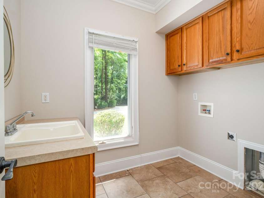 6868 St Peters Lane, Matthews, NC 28105.  MLS# CAR4251557, YatesRealty ID 12768. Landry room on main level