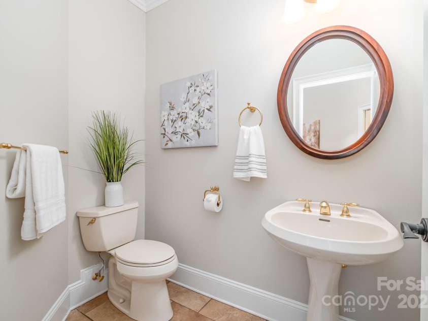 6868 St Peters Lane, Matthews, NC 28105.  MLS# CAR4251557, YatesRealty ID 12768. Powder room on main level