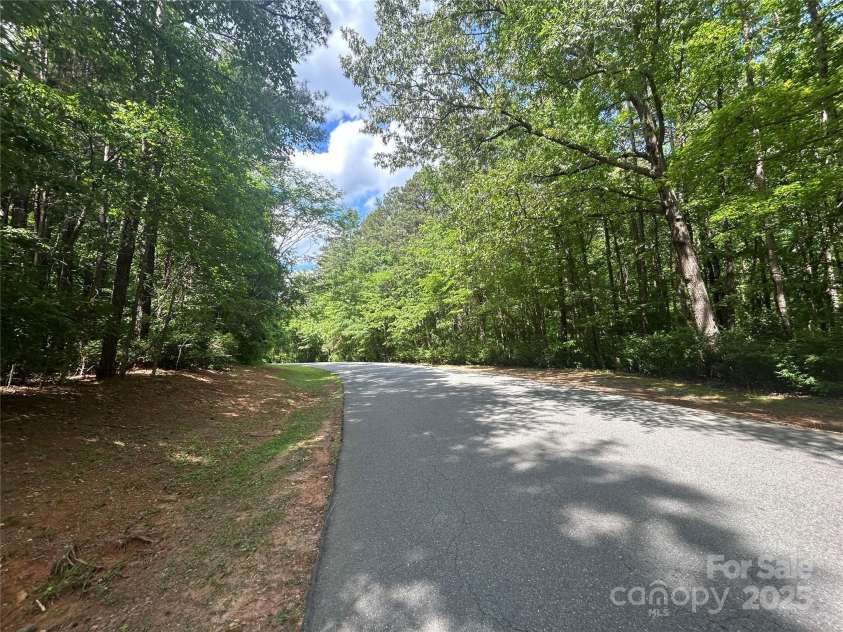 6868 St Peters Lane, Matthews, NC 28105.  MLS# CAR4251557, YatesRealty ID 12768. Semi-private wooded street.
