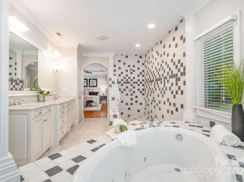 6868 St Peters Lane, Matthews, NC 28105.  MLS# CAR4251557, YatesRealty ID 12768. Spa Inspired primary bathroom - walk in shower