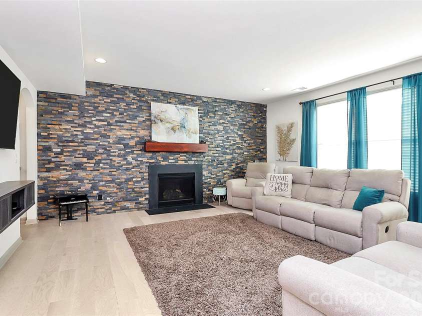 7362 Millstone Circle, Concord, NC 28025.  MLS# CAR4363756, YatesRealty ID 12769. Family room with gas fireplace and stunning accent wall