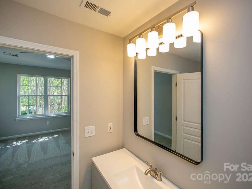 4938 Sunset Ridge Court, Charlotte, NC 28269.  MLS# CAR4256008, YatesRealty ID 12774. And modern lighting and mirrr.
