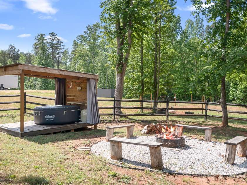 720 Cricket Lane, Mt Ulla, NC 28125.  MLS# CAR4254879, YatesRealty ID 12785. Covered Hot Tub (stays) and firepit area