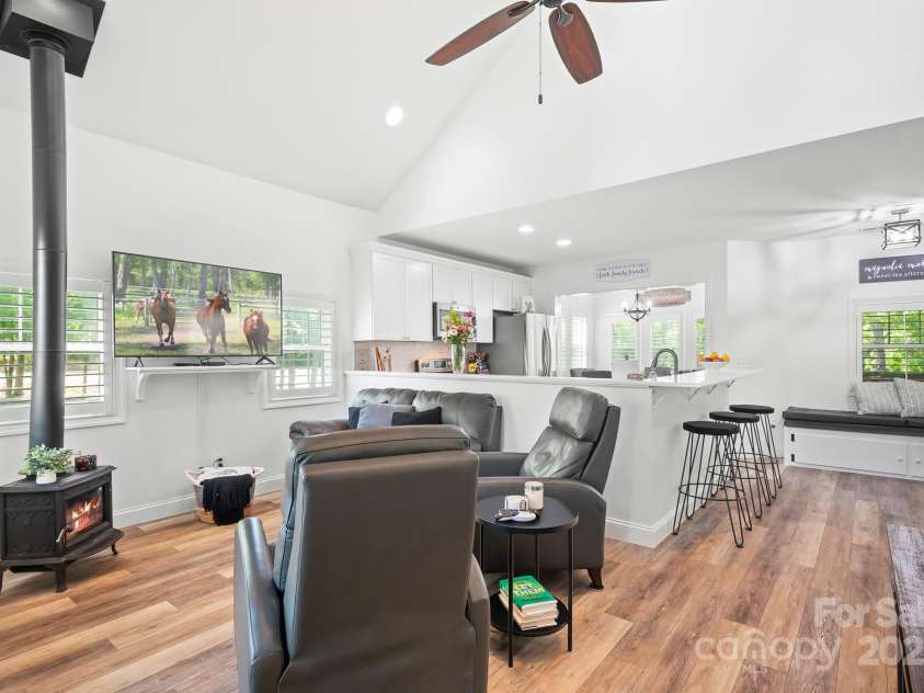 720 Cricket Lane, Mt Ulla, NC 28125.  MLS# CAR4254879, YatesRealty ID 12785. Family room with wood burning stove