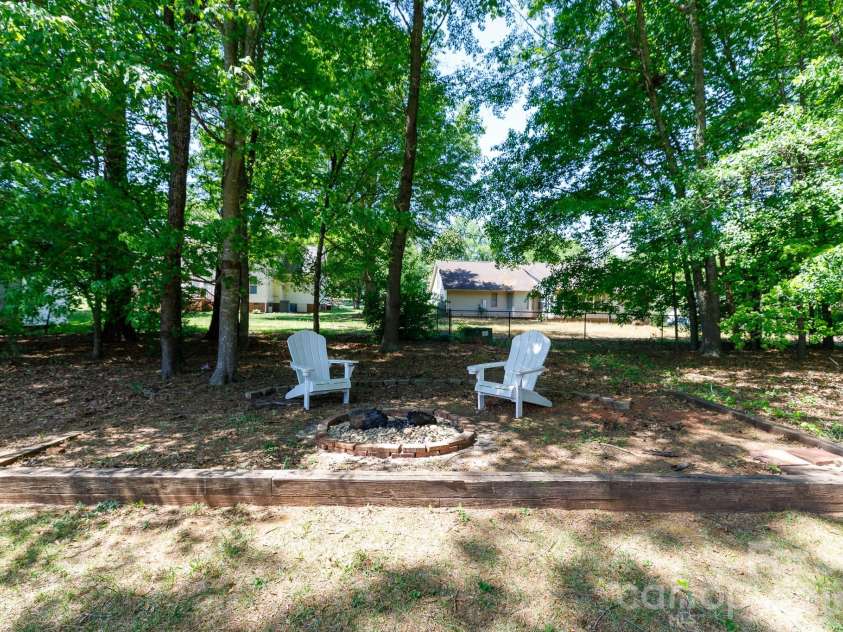 228 Timberlane Drive, Belmont, NC 28012.  MLS# CAR4369910, YatesRealty ID 12788. Fire pit and fenced back yard