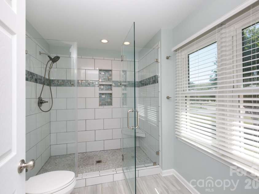 228 Timberlane Drive, Belmont, NC 28012.  MLS# CAR4369910, YatesRealty ID 12788. Walk in tiled shower in primary