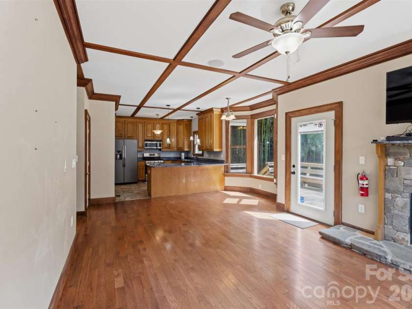 22 Pear Tree Lane, Leicester, NC 28748.  MLS# CAR4371027, YatesRealty ID 12806. Custom, handcrafted trim on ceilings, crown & baseboard in this open floorplan that lends itself to entertaining.
