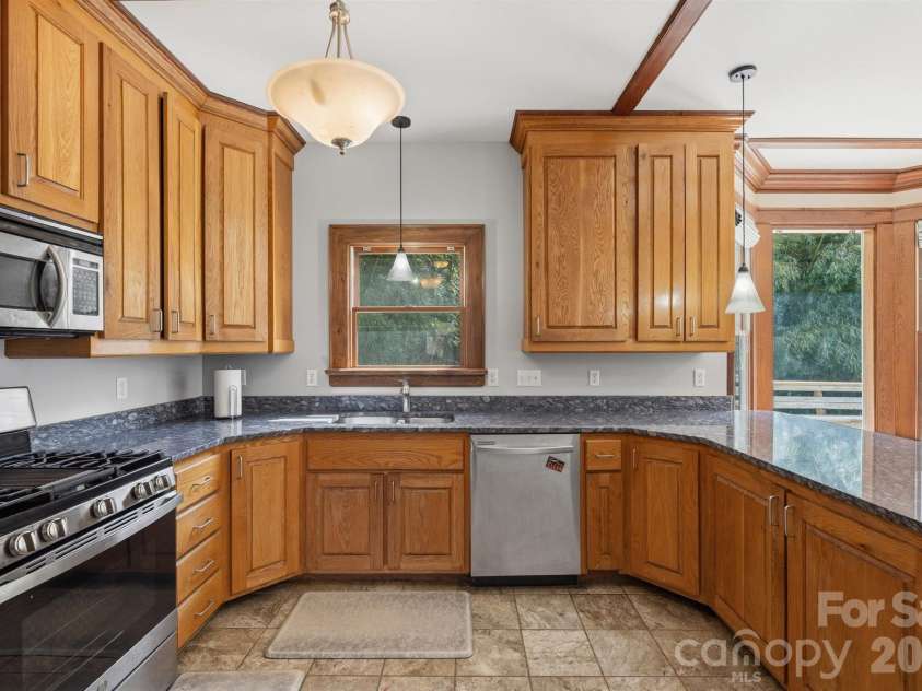 22 Pear Tree Lane, Leicester, NC 28748.  MLS# CAR4371027, YatesRealty ID 12806. Custom, handcrafted white oak cabinetry to the ceiling to maximize space.