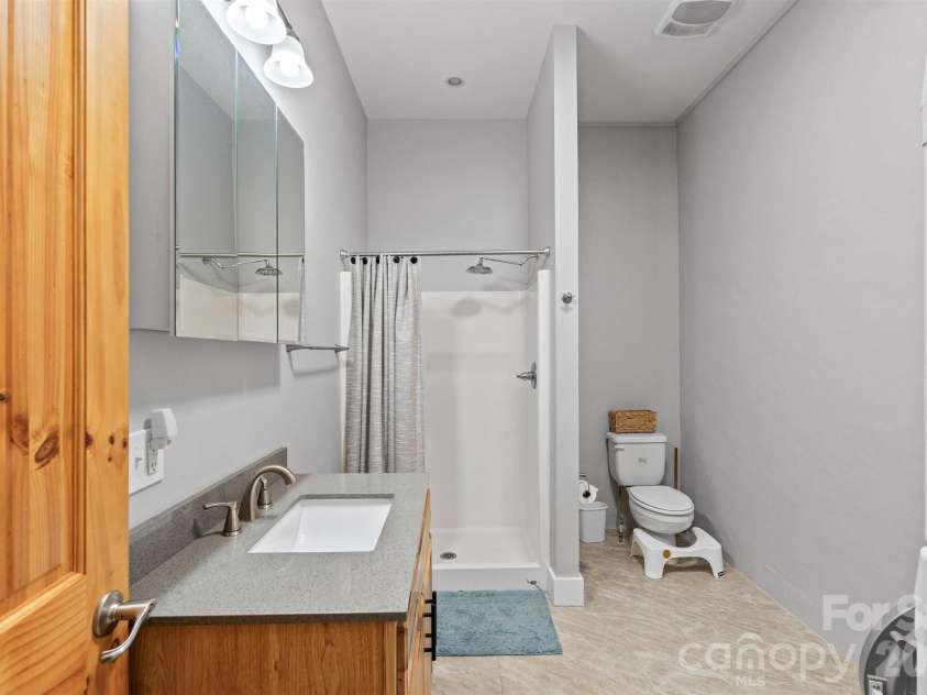 22 Pear Tree Lane, Leicester, NC 28748.  MLS# CAR4371027, YatesRealty ID 12806. Large, full bathroom in the basement level.