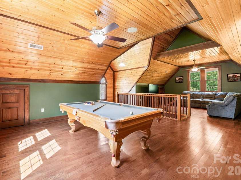 22 Pear Tree Lane, Leicester, NC 28748.  MLS# CAR4371027, YatesRealty ID 12806. Pool table on one side and sectional sofa on the other make this an incredible spot for fun & games.