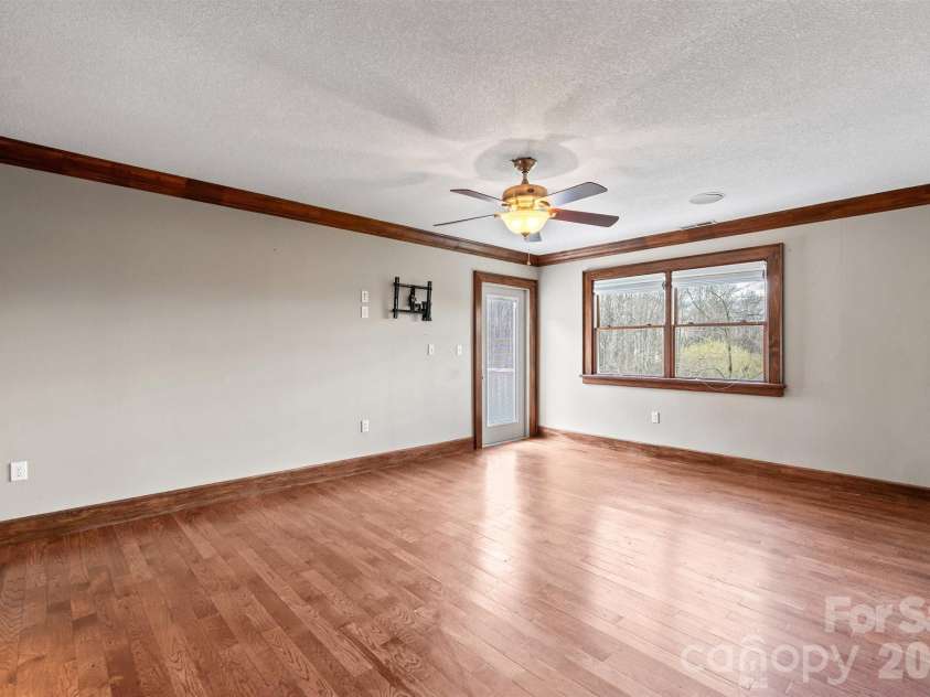 22 Pear Tree Lane, Leicester, NC 28748.  MLS# CAR4371027, YatesRealty ID 12806. Sizeable primary bedroom with its own private deck