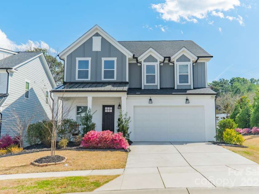5006 Whitman Avenue, Matthews, NC 28105.  MLS# CAR4237851, YatesRealty ID 12807. Front view with rocking chair porch