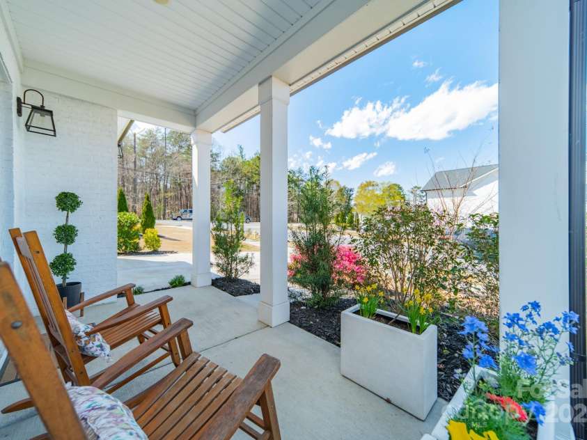 5006 Whitman Avenue, Matthews, NC 28105.  MLS# CAR4237851, YatesRealty ID 12807. Rocking chair front porch