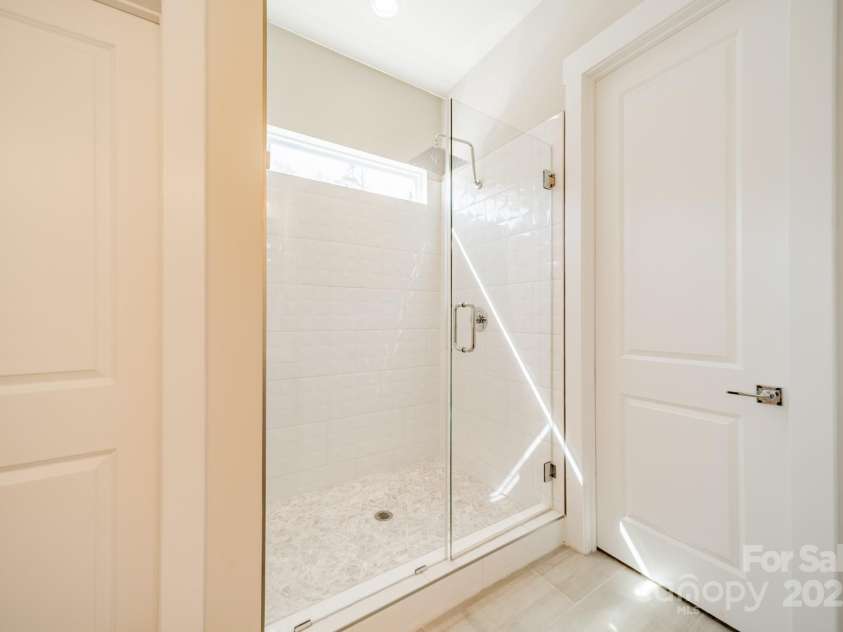 5006 Whitman Avenue, Matthews, NC 28105.  MLS# CAR4237851, YatesRealty ID 12807. Walk-in shower in primary bath