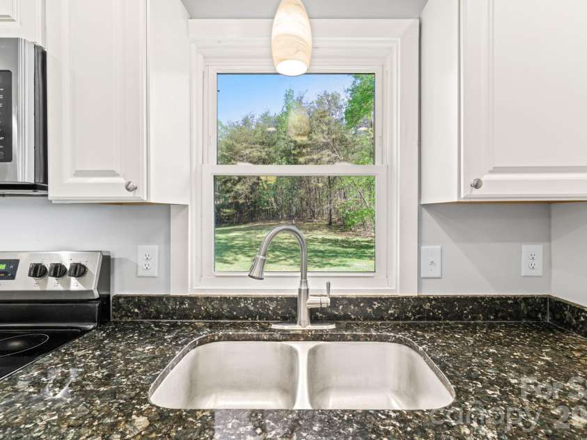154 Cactus Lane, Franklin, NC 28734.  MLS# CAR4353446, YatesRealty ID 12812. Kitchen Window overlooking back yard