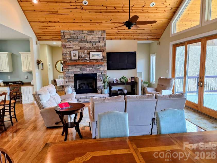 254 Ray Mine Road, Burnsville, NC 28714.  MLS# CAR4351718, YatesRealty ID 12813. Great room with stone fireplace