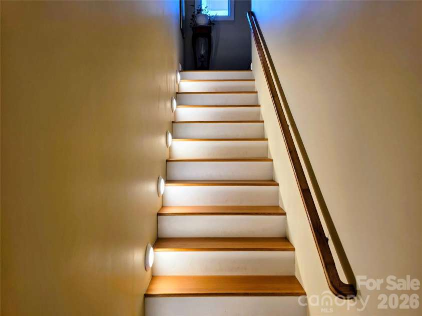 254 Ray Mine Road, Burnsville, NC 28714.  MLS# CAR4351718, YatesRealty ID 12813. Stairs connecting main level and lower level