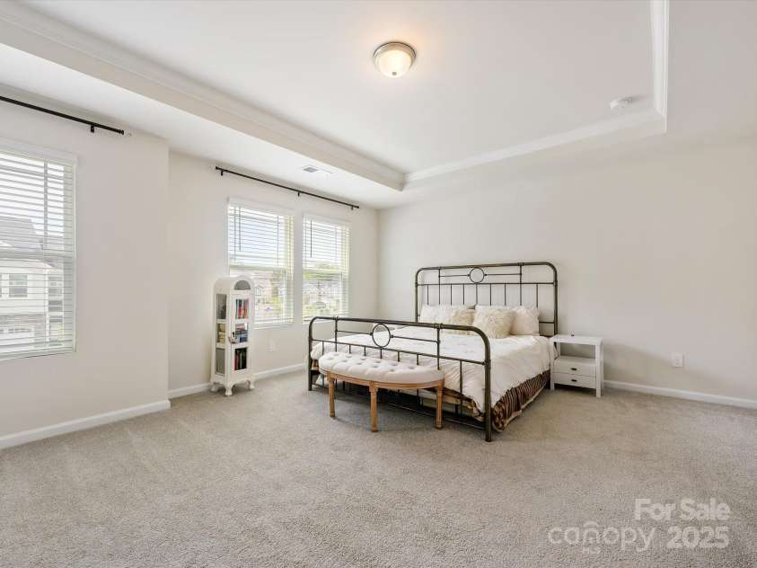 3813 Amalia Place, Indian Land, SC 29707.  MLS# CAR4246224, YatesRealty ID 12822. Second Story Primary Bedroom includes a tray ceiling w/Crown Molding & two walk in wardrobe closets. The ceiling light is also wired for a ceiling fan.