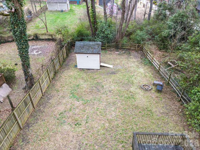 900 Sweetbriar Street, Charlotte, NC 28205.  MLS# CAR4352332, YatesRealty ID 12825. Semi-flat cleared yard makes it easy to add on!