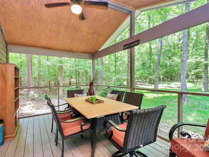 11 Tanglewood Road, Lake Wylie, SC 29710.  MLS# CAR4237959, YatesRealty ID 12829. Designed for year-round enjoyment, this spacious screened porch offers ample space for dining, lounging, and entertaining.